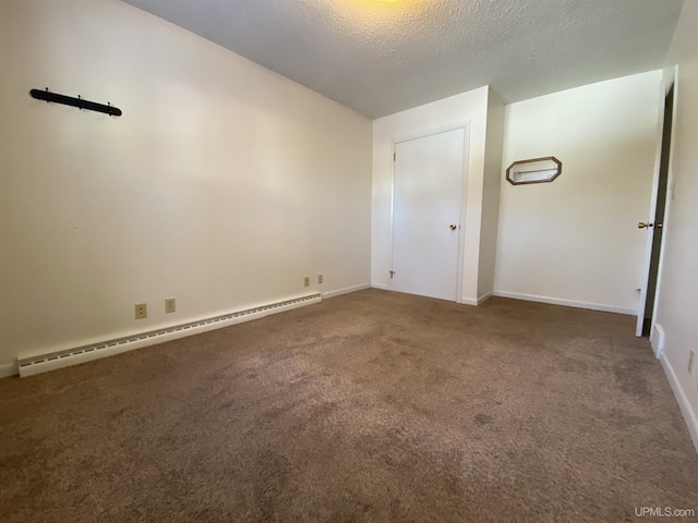 unfurnished bedroom with dark colored carpet, a textured ceiling, and baseboard heating