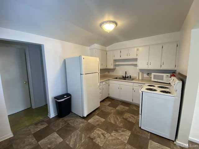 kitchen featuring white cabinetry, white appliances, sink, and vaulted ceiling