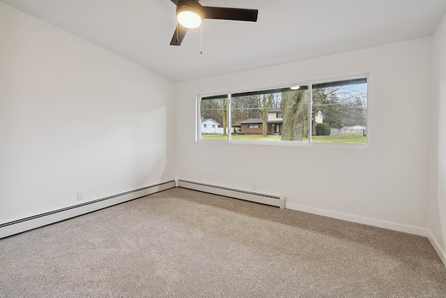 carpeted spare room featuring ceiling fan and a baseboard heating unit