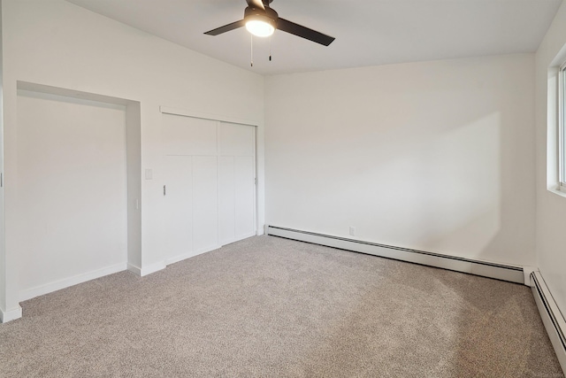 unfurnished bedroom with carpet flooring, ceiling fan, a closet, and a baseboard heating unit