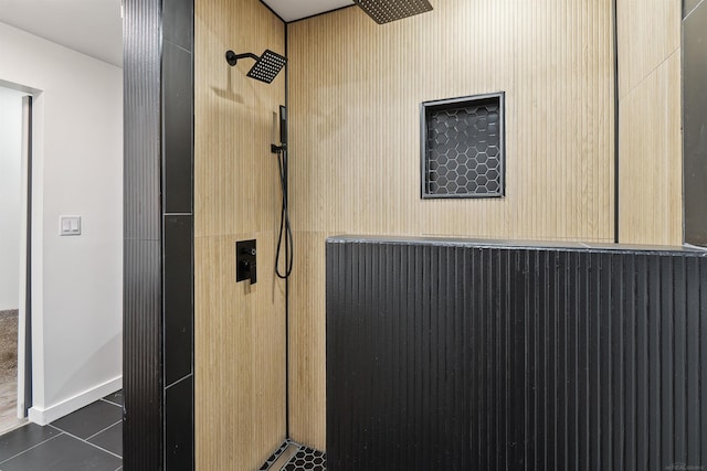 bathroom featuring tile patterned flooring and tiled shower