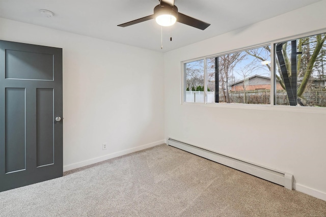 empty room featuring carpet, ceiling fan, and baseboard heating