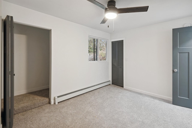 unfurnished bedroom featuring ceiling fan, a closet, light carpet, and a baseboard heating unit