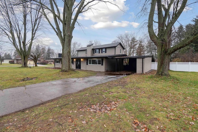 view of front of property with a front lawn and a carport