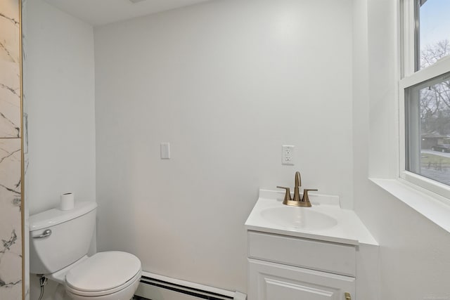 bathroom featuring vanity, toilet, and baseboard heating