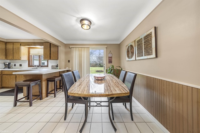 tiled dining room with wooden walls