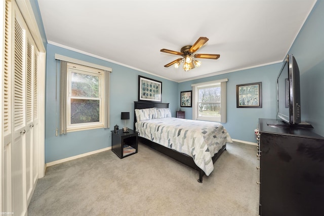 bedroom featuring light colored carpet, multiple windows, crown molding, and ceiling fan