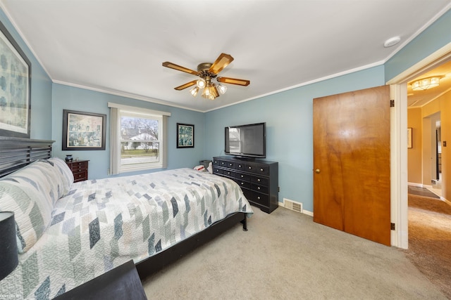 carpeted bedroom featuring ceiling fan and ornamental molding