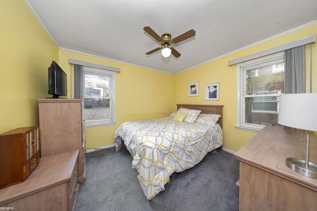 bedroom with ceiling fan, dark carpet, and ornamental molding