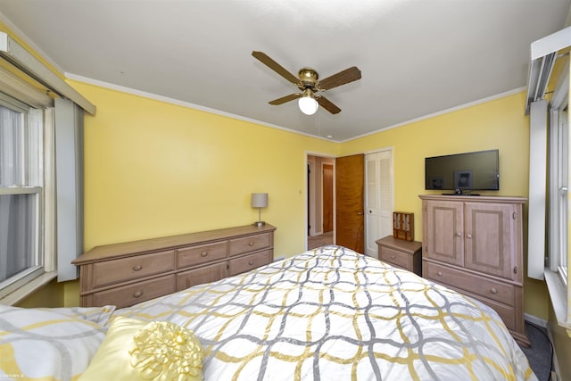 bedroom with carpet, a closet, ceiling fan, and ornamental molding