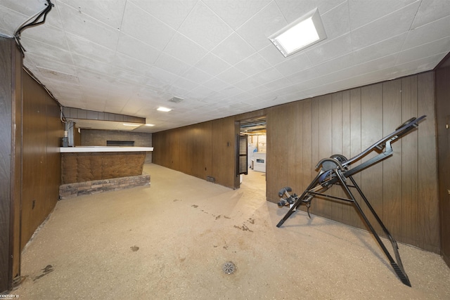 basement featuring wood walls