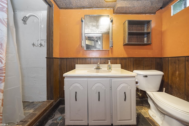 bathroom with a shower with shower curtain, vanity, toilet, and wooden walls