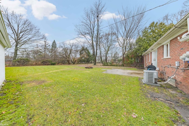 view of yard featuring central air condition unit and a patio