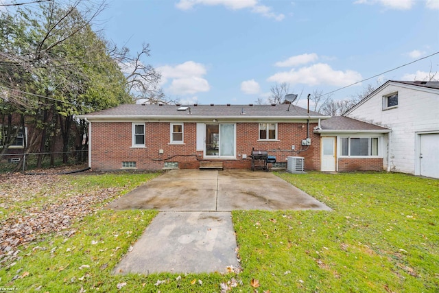 rear view of house with central air condition unit, a lawn, and a patio