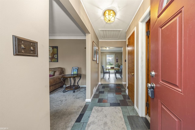 view of carpeted foyer entrance