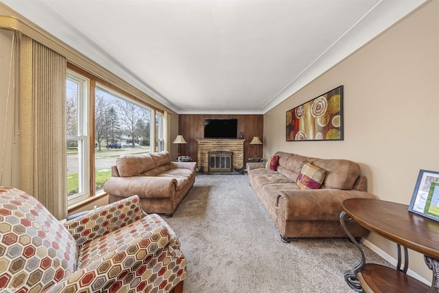 carpeted living room with a fireplace and crown molding