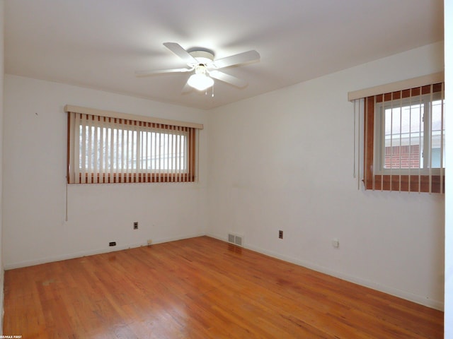 unfurnished room with wood-type flooring and ceiling fan