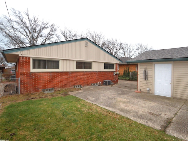 view of home's exterior featuring central AC unit, a patio area, and a lawn