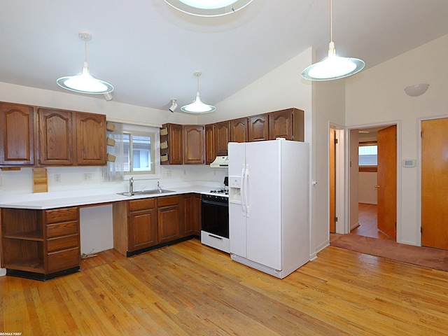 kitchen featuring light hardwood / wood-style flooring, pendant lighting, white appliances, and sink