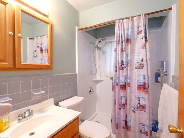 bathroom with walk in shower, vanity, toilet, and tile walls