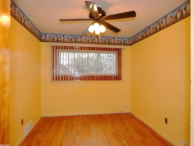 unfurnished room with hardwood / wood-style flooring, plenty of natural light, and ceiling fan