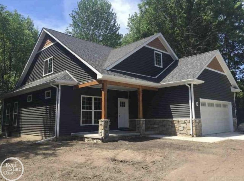 craftsman inspired home featuring a garage and covered porch