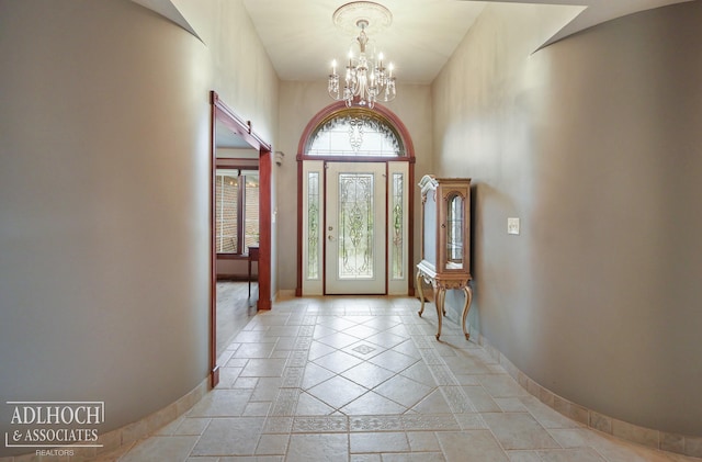 entryway featuring a high ceiling and an inviting chandelier