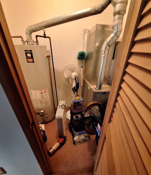 utility room featuring water heater