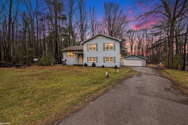 view of front of property featuring a yard, an outbuilding, and a garage