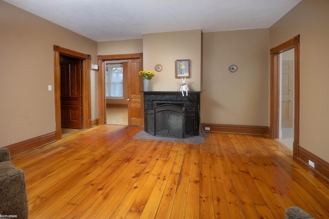 unfurnished living room with light hardwood / wood-style flooring