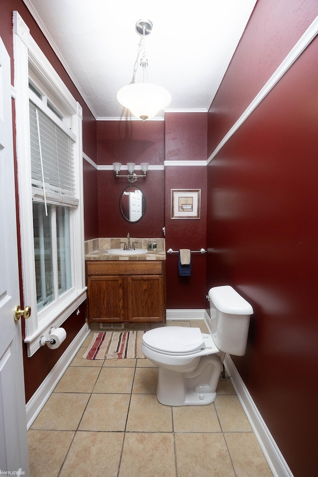 bathroom with vanity, ornamental molding, tile patterned floors, and toilet