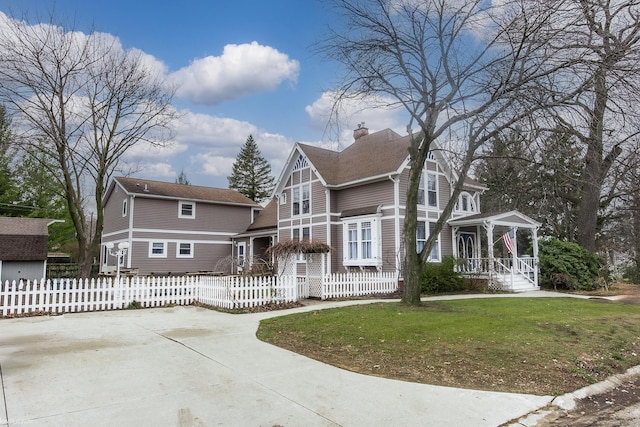 view of front of home with a front yard and a porch