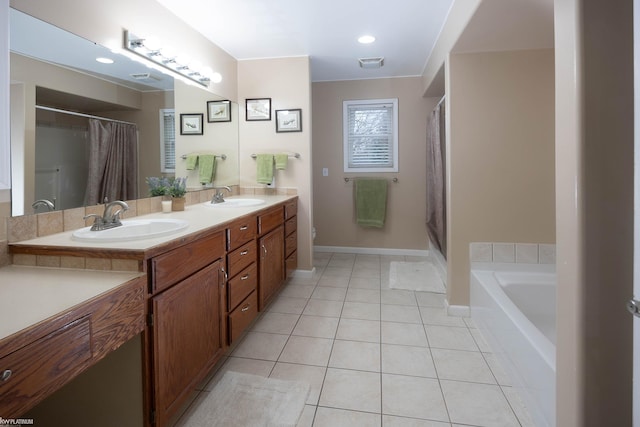 bathroom featuring vanity, tile patterned floors, and a bathtub