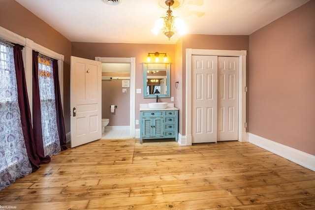 bathroom with vanity, hardwood / wood-style floors, and toilet