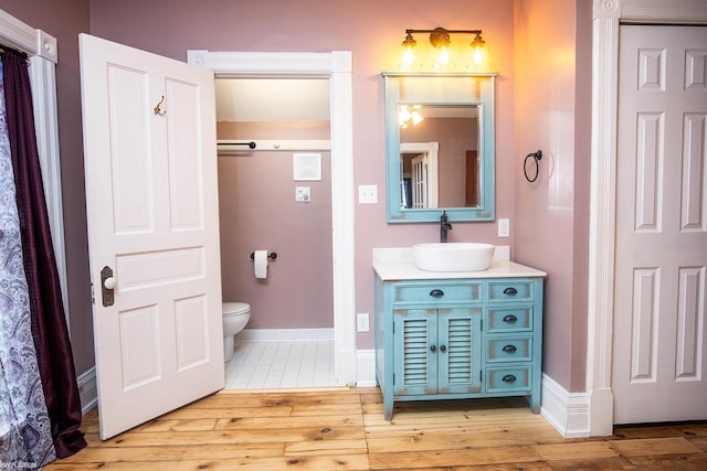 bathroom with vanity, hardwood / wood-style floors, and toilet