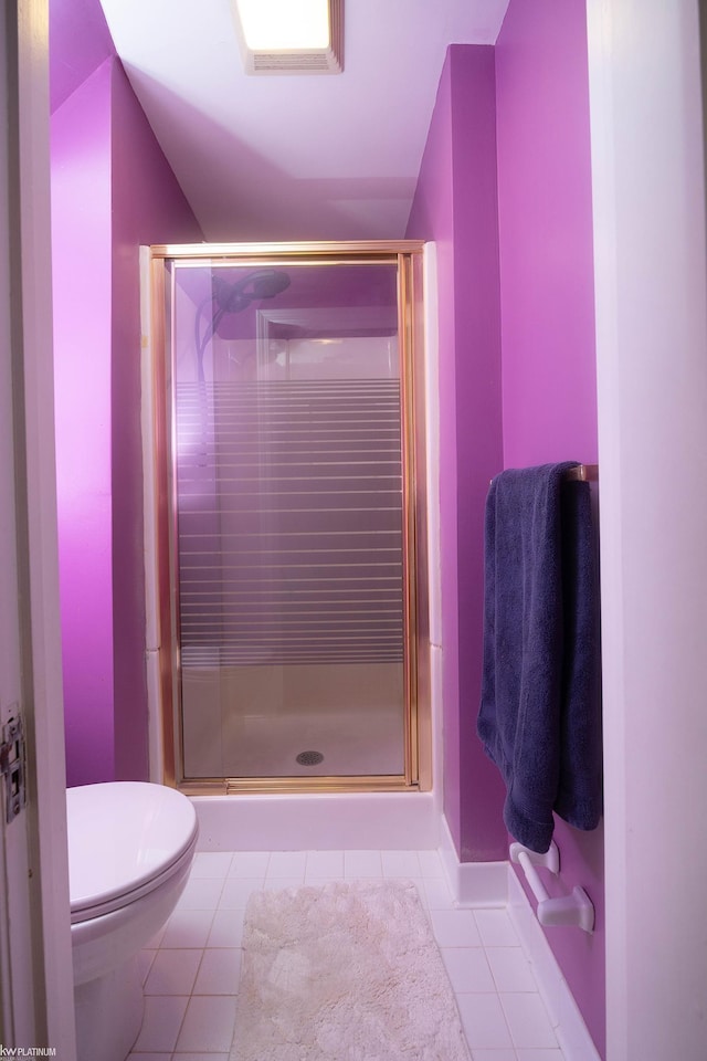 bathroom featuring tile patterned flooring, an enclosed shower, and toilet