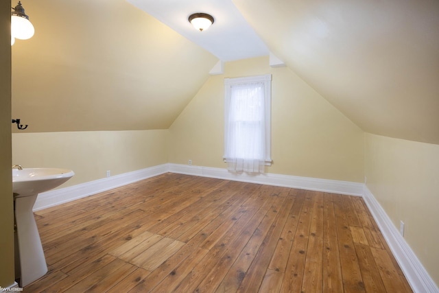 bonus room featuring lofted ceiling and hardwood / wood-style flooring