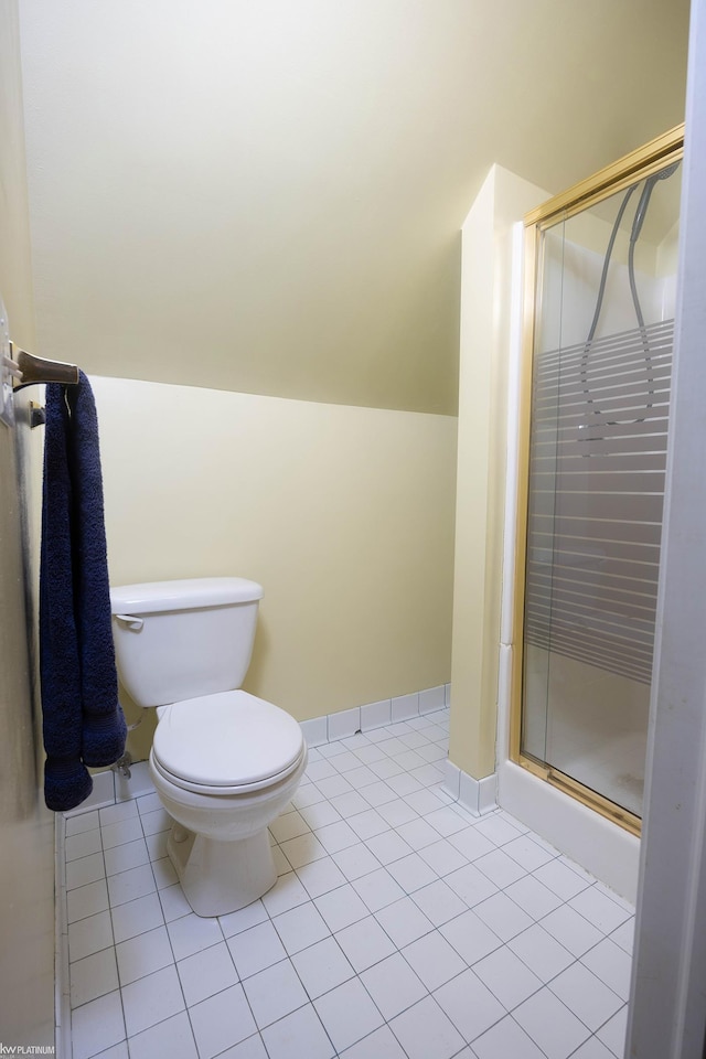 bathroom featuring vaulted ceiling, tile patterned floors, toilet, and walk in shower