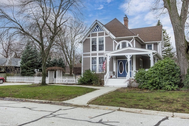 victorian house featuring a front lawn