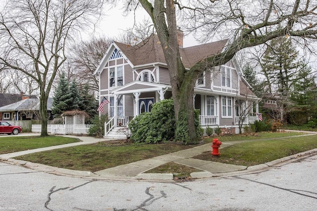 victorian house with a front yard