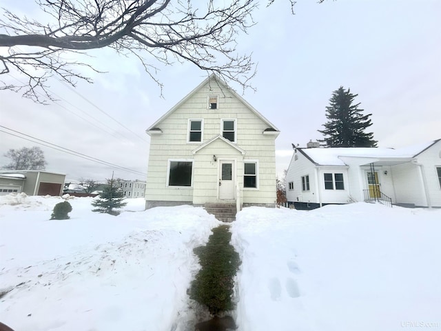 view of snow covered rear of property