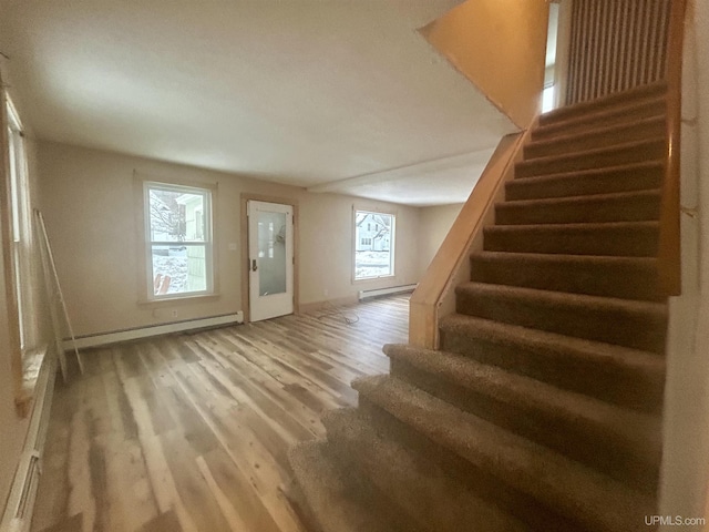 301 E Chocolay St, Munising, MI 49862 - interior space featuring a baseboard heating unit, baseboard heating, and wood finished floors