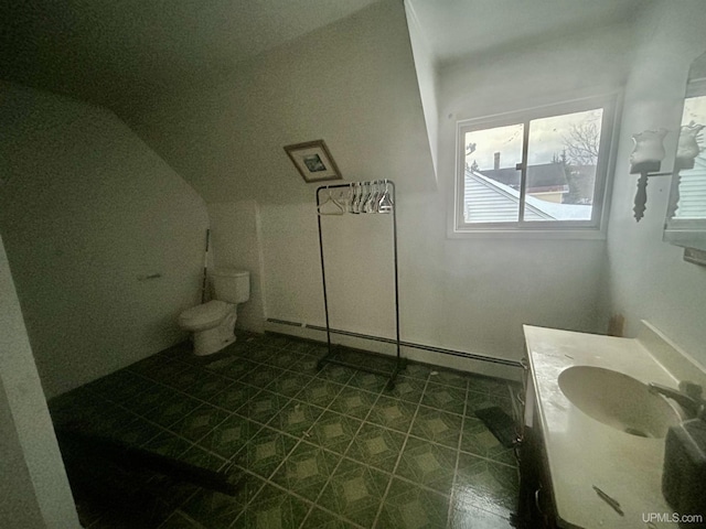 301 E Chocolay St, Munising, MI 49862 - bathroom with a baseboard heating unit, tile patterned flooring, vanity, and lofted ceiling