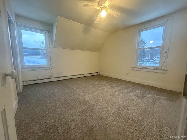 301 E Chocolay St, Munising, MI 49862 - additional living space with a baseboard radiator, carpet floors, vaulted ceiling, and a ceiling fan