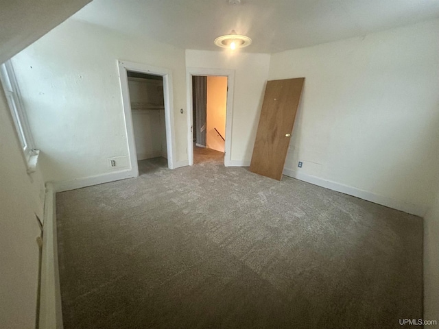 301 E Chocolay St, Munising, MI 49862 - unfurnished bedroom with carpet and a closet