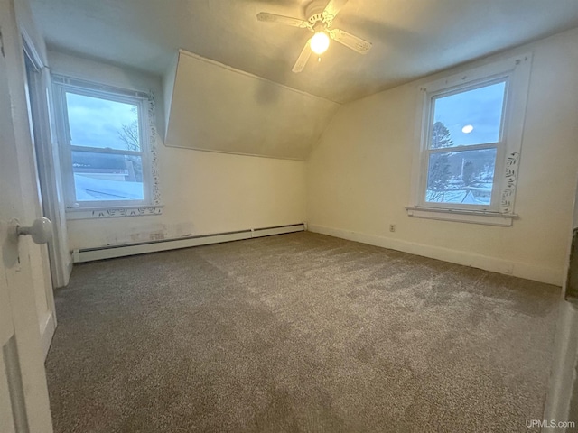 additional living space with baseboard heating, ceiling fan, carpet, and lofted ceiling