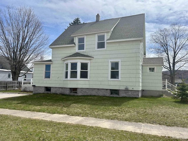 301 E Chocolay St, Munising, MI 49862 - view of property exterior with roof with shingles and a chimney