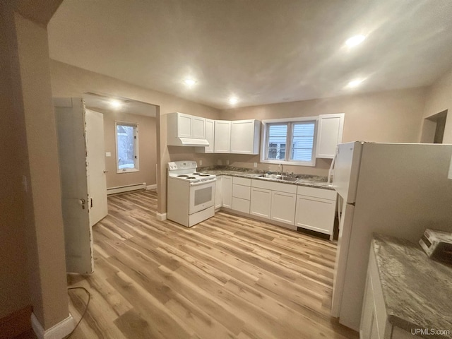 301 E Chocolay St, Munising, MI 49862 - kitchen with white appliances, a baseboard radiator, white cabinets, light wood-style floors, and under cabinet range hood