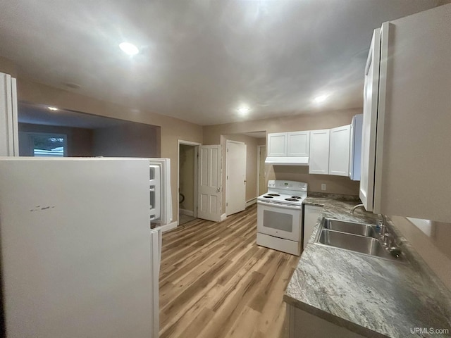 301 E Chocolay St, Munising, MI 49862 - kitchen featuring white appliances, light wood finished floors, white cabinets, under cabinet range hood, and recessed lighting