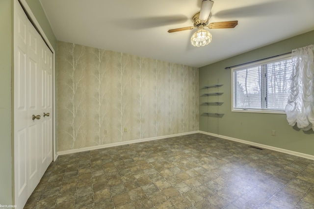 unfurnished room with ceiling fan